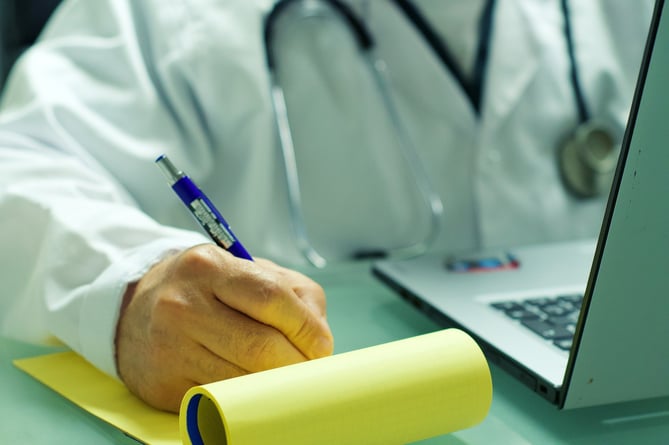File image of a doctor writing a prescription