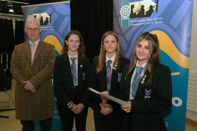 Pictured with Stephen Thornton of Valero are a Vocal Trio from Haverfordwest High VC School who won the Open Vocal Ensemble class; Ruby Panesar, Honey Johnston and Libby Banner.