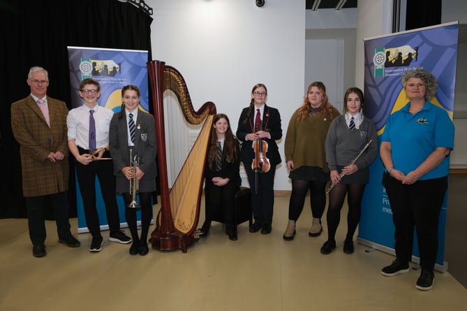 Pictured is the overall winner, harpist Eliza Bradbury (centre) with the winners of the open competitions (left to right) Dylan Sanders-Swales, Carys Wood, Jenifer Rees, Heledd Richardson and Anya Beynon-Krampf, with Stephen Thornton of Valero (left) and Philippa Roberts of Pembrokeshire Music Service (right).