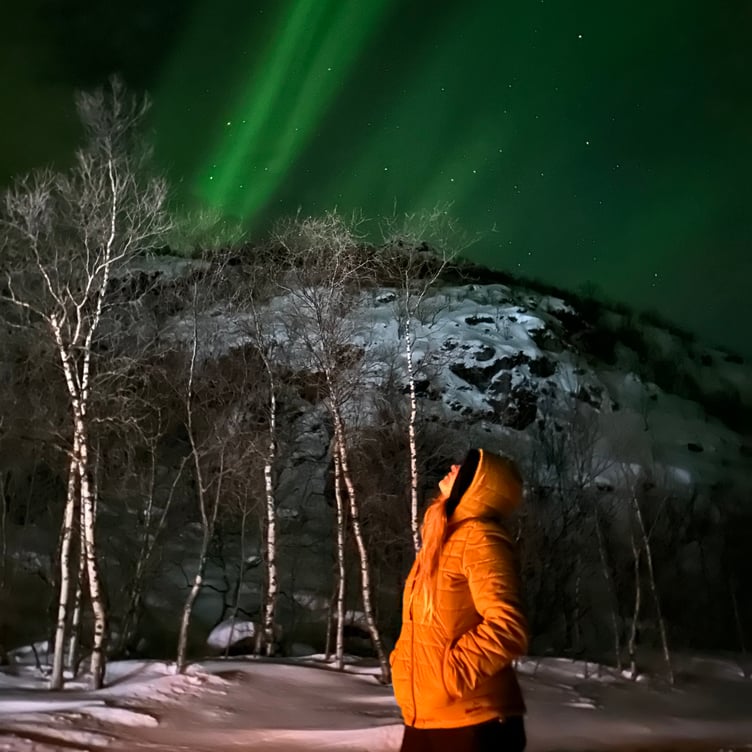 Jodie Marie looking up at the Northern Lights
