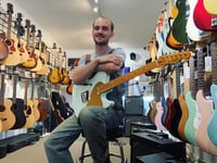 TV crew visiting Pembroke check out guitar George