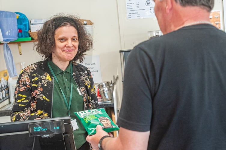 Sarah serving customers in the Station Shop