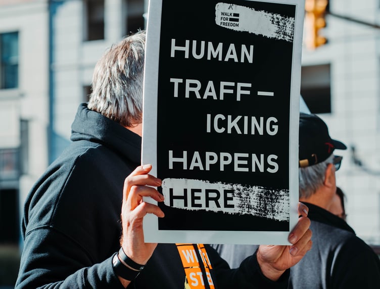 Human trafficking protester holding sign