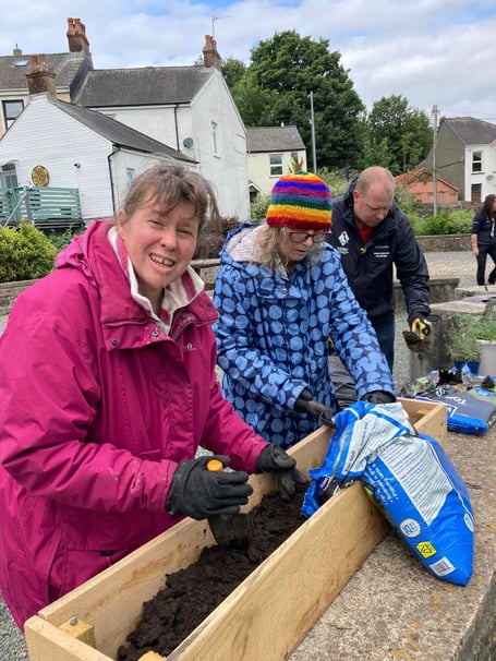 Roots to Recovery volunteers planting the Herb Boxes they created for Pembroke Commons Gardens