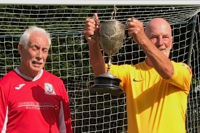 Mark Brindley, the captain of NHSU being presented with the cup from the Welsh captain.