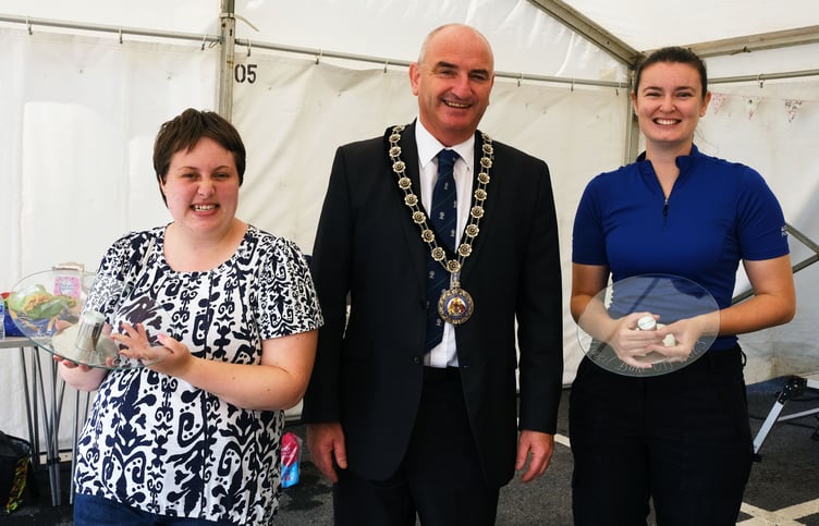 Annual Council Bake Off winners Amber Baker and Beth Hawkridge with Cllr Tom Tudor.