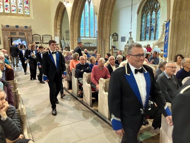 Members of Goodwick Brass Band marching to perform.