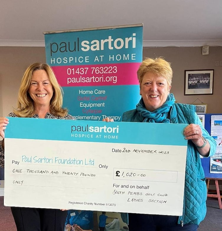 Previous Trustee and Voting Member of the Paul Sartori Foundation Sara Alderman is handed a cheque from Ladies Captain Joanne Owen.