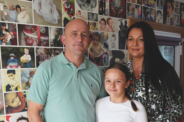 Jason, Besi and Sara Morris at home