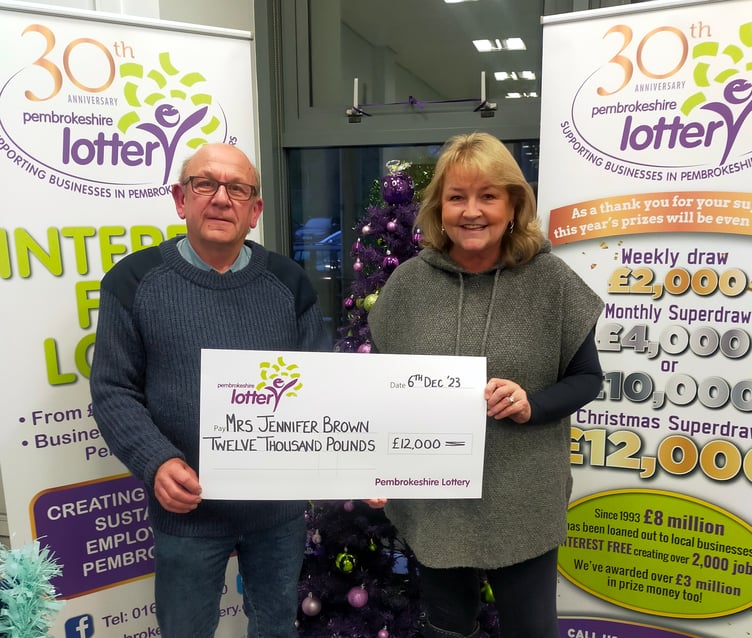 Jennifer collecting her winning cheque for £12,000