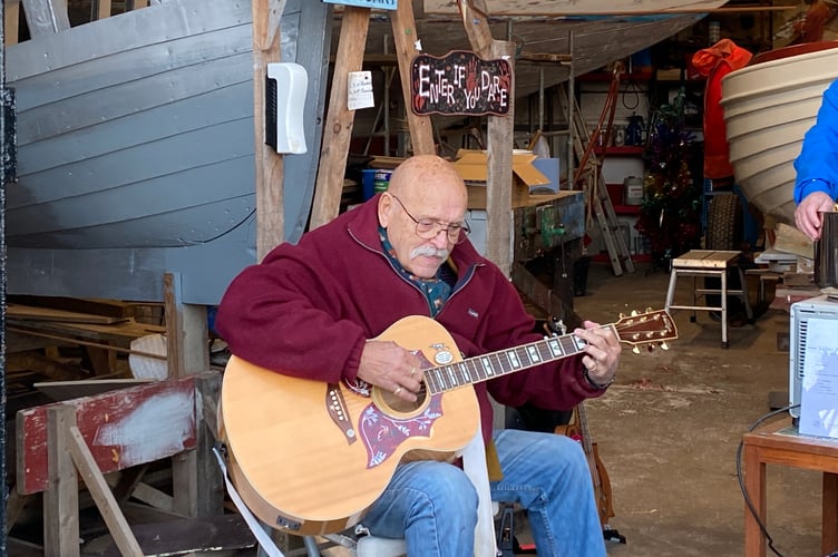 Sid Colson accompanying himself on the guitar during the event at Pembroke Dock Maritime Museum on Tuesday afternoon.