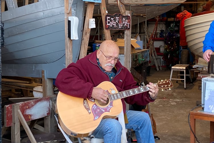 Sid Colson accompanying himself on the guitar during the event at Pembroke Dock Maritime Museum on Tuesday afternoon.