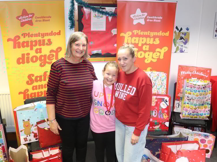 Sue Marsden, Grace and Kirsty with the presents in Llanelli office of Action for Children