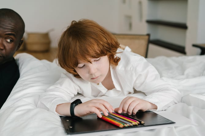 Photo by Mikhail Nilov: https://www.pexels.com/photo/photo-of-a-child-with-red-hair-looking-at-colored-pencils-8654551/
