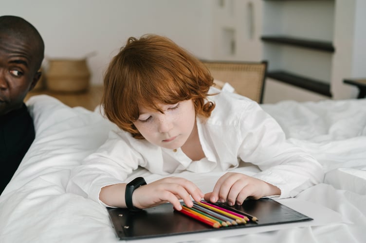Photo by Mikhail Nilov: https://www.pexels.com/photo/photo-of-a-child-with-red-hair-looking-at-colored-pencils-8654551/
