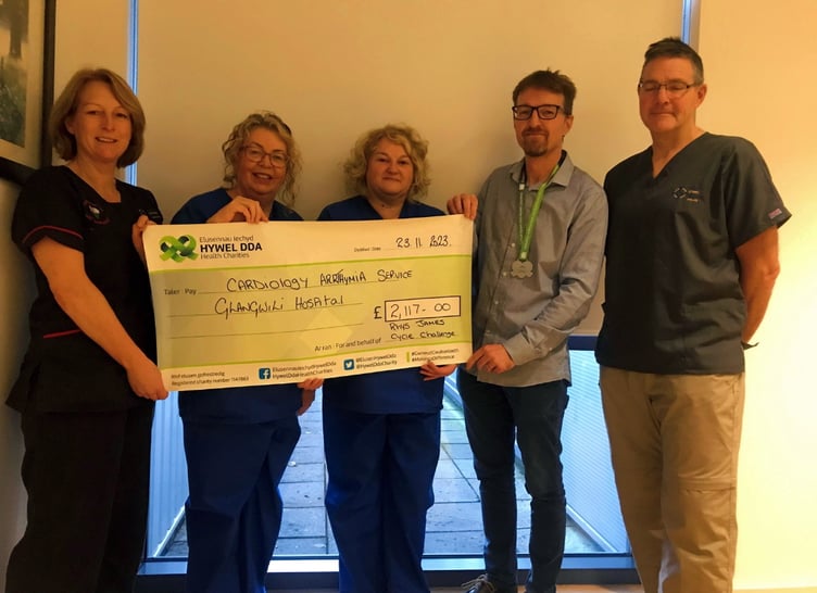 Receiving the cheque from Rhys James are Dr Adrian Raybould, Consultant Cardiologist; Jennifer Matthews, Advanced Nurse Practitioner Arrhythmia; Nerys James, Cardiac and Respiratory Healthcare Sciences Manager and Andrea Evans, Clinical Nurse Specialist Arrhythmia.