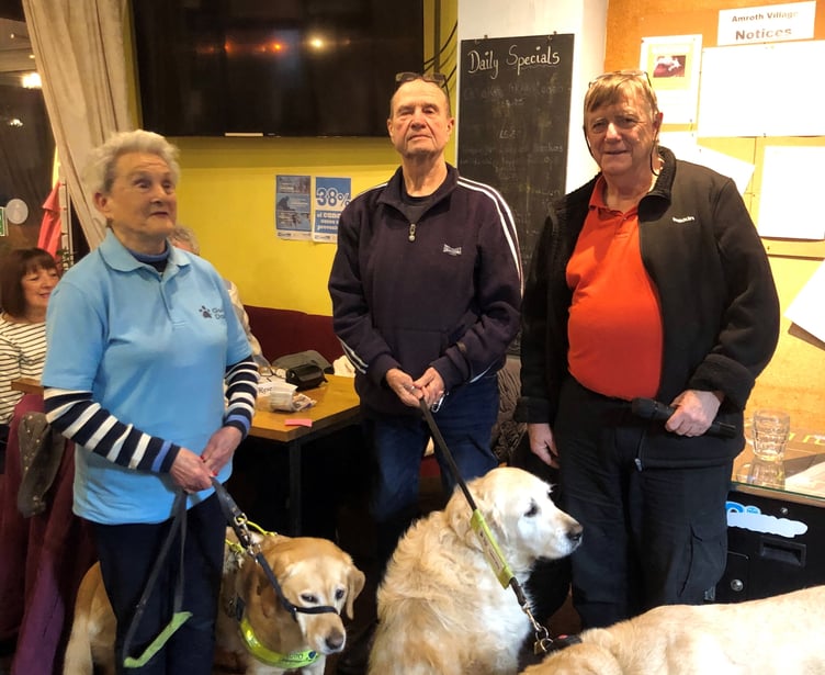 Pictured at a Guide Dogs Cymru Quiz Night at the Templebar Inn, Amroth, are Eva Rich with Nancy, John Woolsgrove with Eddie and Ian from the Templebar Inn with his dog Max.