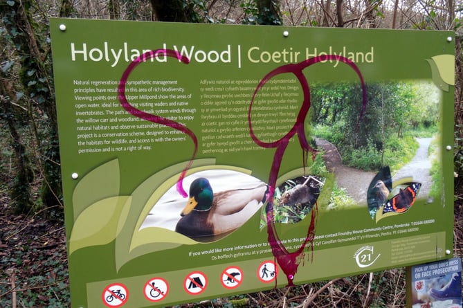 A defaced sign at Holyland Wood in Pembroke, where vandalism is one of the factors affecting the upkeep of the volunteer-run nature reserve.
