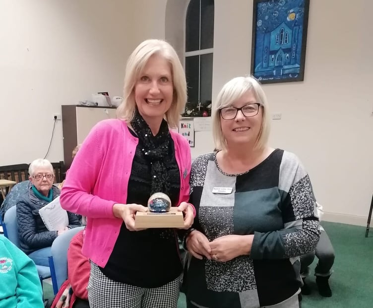 Chairlady Sandra Western presents the paperweight in memory of Grace Lewis to choir secretary Alison Davies.