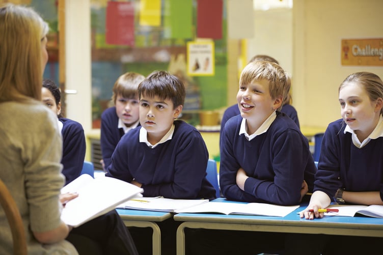 School mixed class in uniform with teacher - stock image