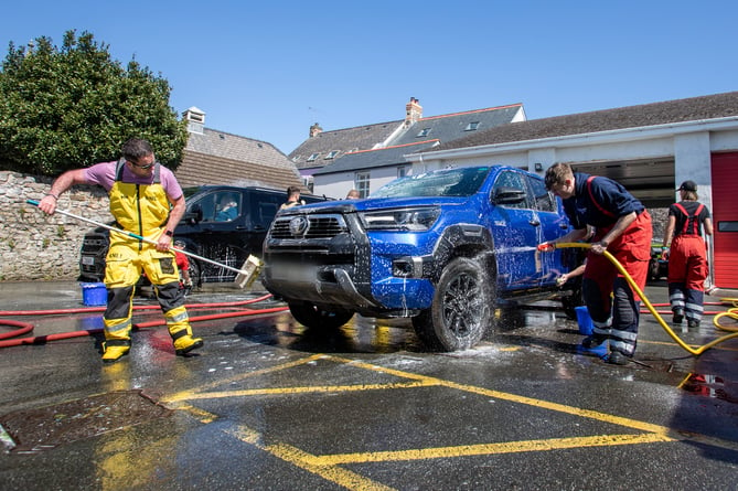 Firefighters from the on-call fire crew at Tenby Fire Station and Tenby RNLI Station, made the most of the hot, sunny weather over the weekend with a fundraising car wash to raise money for the RNLI. The fire station, based in the heart of the hugely popular seaside resort of Tenby, Pembrokeshire, is well known for the fundraising activities they do. The car wash also attracted fellow emergency service, The Welsh Ambulance.