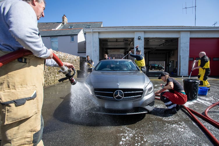Firefighters from the on-call fire crew at Tenby Fire Station and Tenby RNLI Station, made the most of the hot, sunny weather over the weekend with a fundraising car wash to raise money for the RNLI. The fire station, based in the heart of the hugely popular seaside resort of Tenby, Pembrokeshire, is well known for the fundraising activities they do. The car wash also attracted fellow emergency service, The Welsh Ambulance.