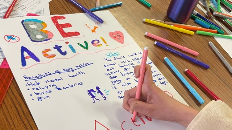 Activity poster being drawn by 2nd Newtown Guides
