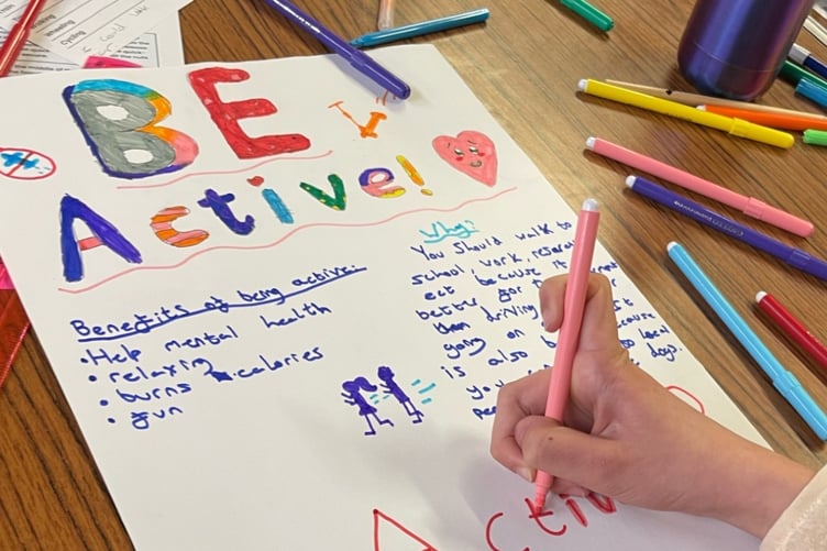 Activity poster being drawn by 2nd Newtown Guides