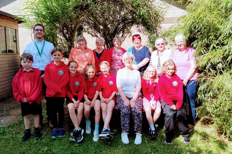 Children of Stepaside school with Headmaster Mr Peter Jones at the presentation of the 'Buddy bench’ kindly donated by Kilgetty WI.