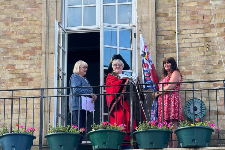 Mayor Cllr Maria Williams raising the D-Day flag Pembroke Dock Pater Hall.