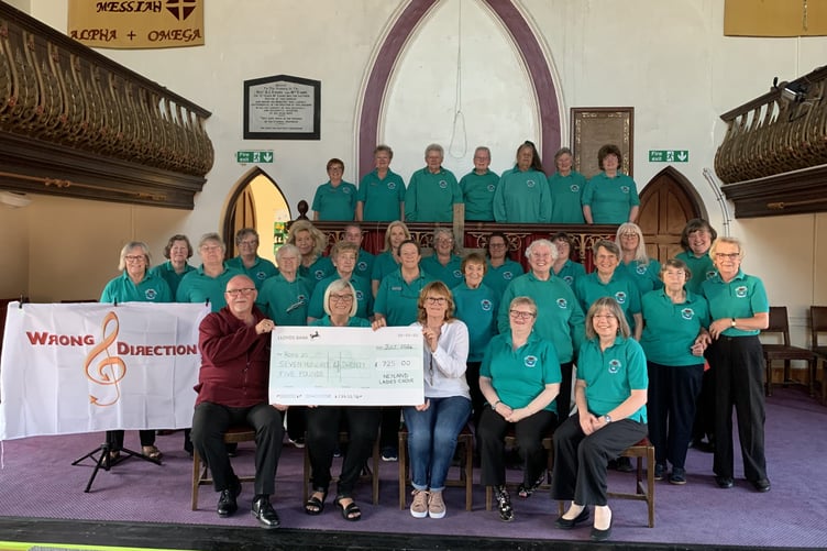 Neyland Ladies Choir with Neil martin from Wrong Direction, presenting a cheque to Tracey of Roko 20 Academy charity