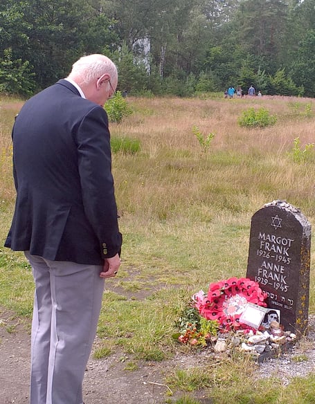Cllr Aden Brinn, Pembroke, lays a poppy wreath by the headstone of Ann and Margot Frank during his visit to twin town Bergen.