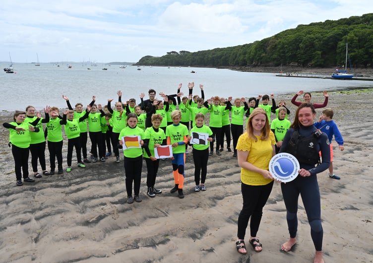 Sara Richards from the Port of Milford Haven (front left) and Miyah Periam (front right), Senior Instructor at Windswept, with Year 6 pupils from Cleddau Reach School at Dale beach.