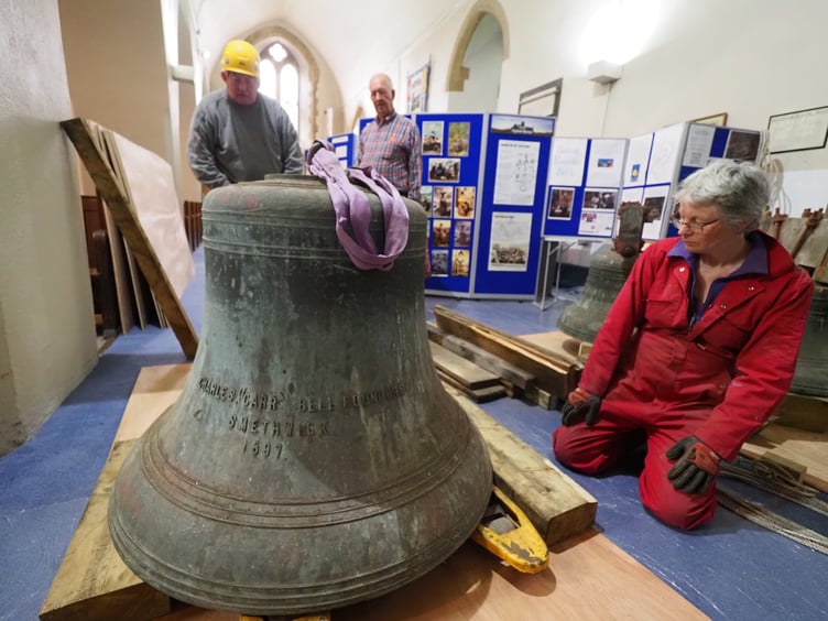 Tower Captain Anne looking at the tenor bell (648 kg) on the floor of St Mary’s Church. Credit: Francis Bunker