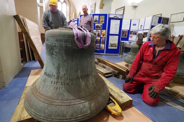 Tower Captain Anne looking at the tenor bell (648 kg) on the floor of St Mary’s Church. Credit: Francis Bunker