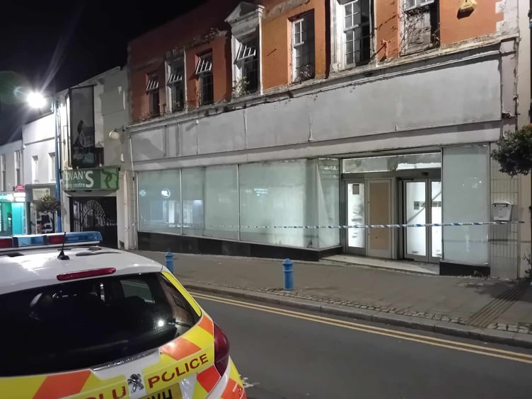 Police vehicle and tape at the former Woolworths store, Dimond Street, Pembroke Dock, on September 3.