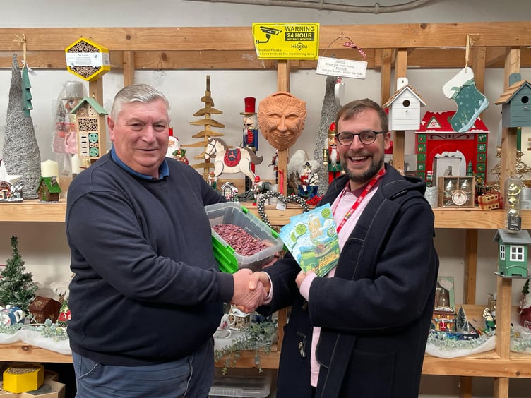 David Charles from Elder Meadows Nursery giving a large bag of beans to Tim Howe, from the Torch Theatre for the 'Magical Beans' competition - part of this year's Torch Christmas pantomime of Jack and the Beanstalk.