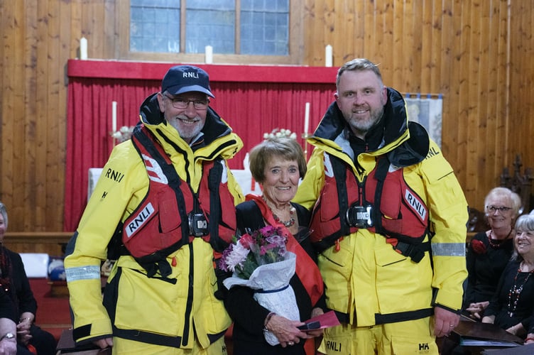 Representatives from the Angle Lifeboat RNLI crew, in full uniform, presented long-standing Neyland Ladies Choir member Dorothy Beckett with a long service medal and flowers.