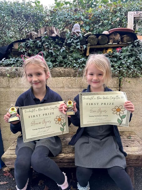 Pictured are Eleanor Ayers (6) and Evie Ayers (4) being awarded their Saundersfoot in Bloom Young Gardeners awards at Templeton Primary School.