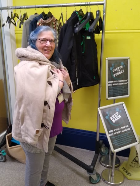 Tenby Library warm coat rail donation being modelled