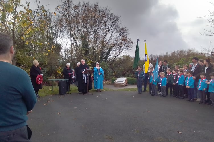 A large group of local residents gathered in Kilgetty Community Garden for a service of Remembrance last Sunday. Then Scout representatives lowered their standards for the two-minute silence. After the singing of both national anthems, representatives of local groups laid wreaths and crosses around the memorial plaque which honours men of Kilgetty and Begelly.
