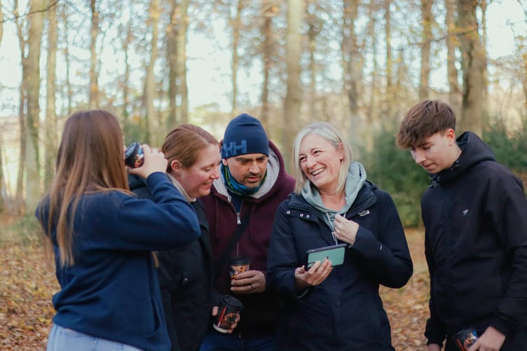 Family group in nature - woodland walk, orienteering, in autumn