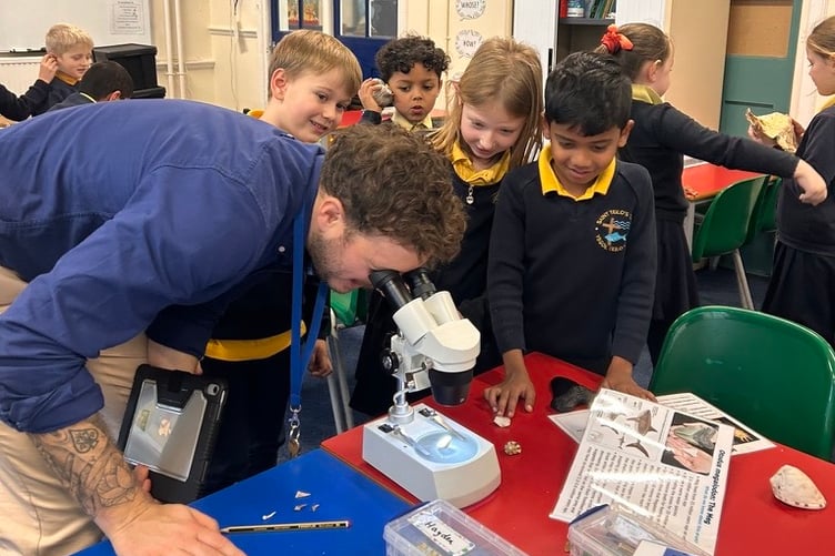 Mr Jones examining a shell with St Teilo’s School Tenby pupils
