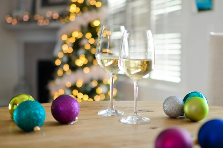 Wine glasses and Christmas baubles - party stock image