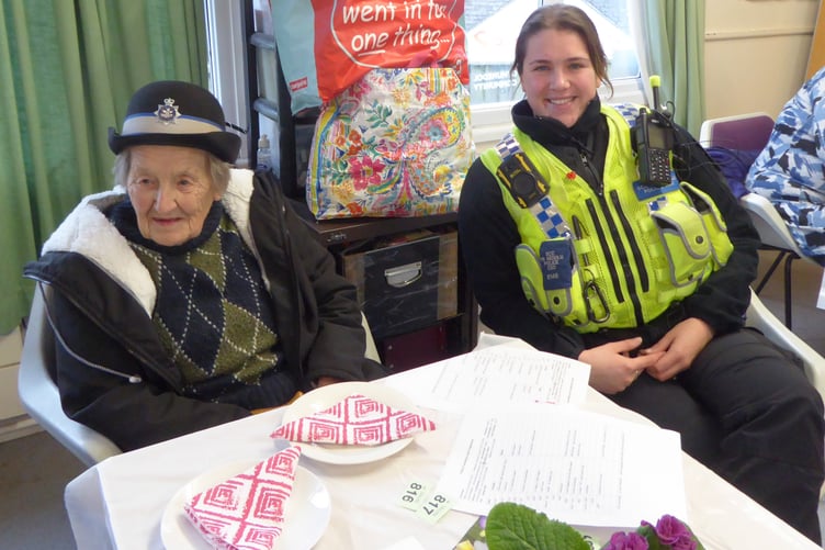 About 30 Tenby Friendship Club members welcomed a policewoman to their special New Year’s tea last Wednesday, with Sheila looking after her hat while she circulated!