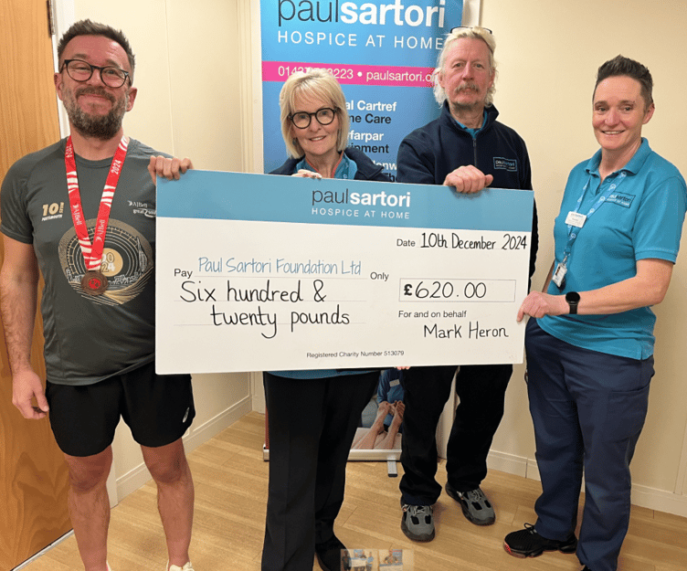 Nothing daunted following the cancellation of The Great South Run last year, Paul Sartori Community Choir director Mark Heron laced up his running shoes and completed his own 10-mile run in Carmarthen, raising £620 for the hospice at home charity. Mark is pictured with Clinical Coordinator and Equipment Facilitator Pat Coombs, and Equipment team members Jerry Hilliar and Amanda Elmes.