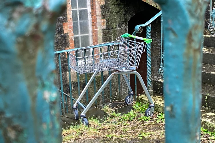 Supermarket trolley outside church building in Pembroke Dock