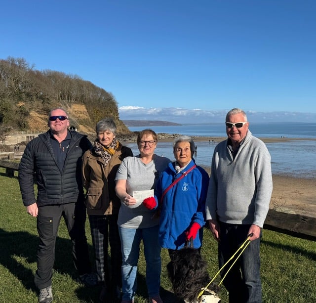 Tenfoot Swim representatives donating the £1,125 raised to local Guide Dogs Cymru branch members. Pictured, from left to right: Anthony Mattick, Kim Denning, Lynn Knibbs, Eva Rich, Adge John and guide dog Skip