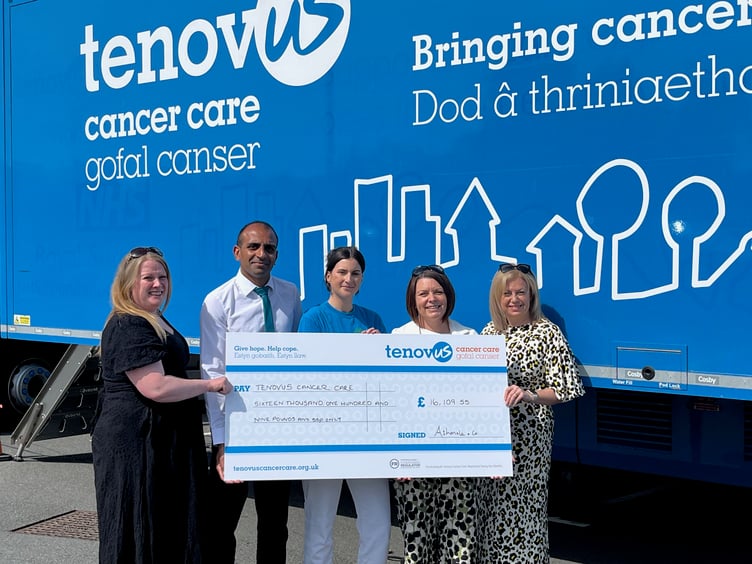 Ashmole & Co Partners Christine Daultrey, Vinal Patel, Sharon George and Laura Craddock handing over a cheque for £16,109.55 to Clare Davies (centre), Regional Fundraising Manager for Tenovus Cancer Care outside one of the mobile support units.
