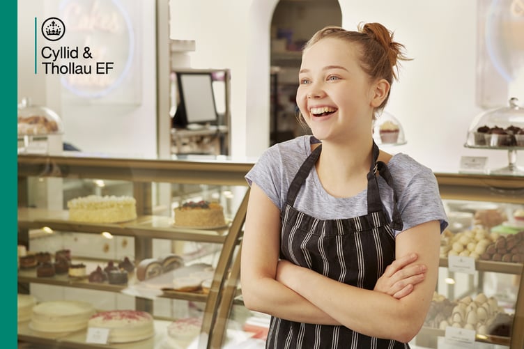 Young woman working at cake counter